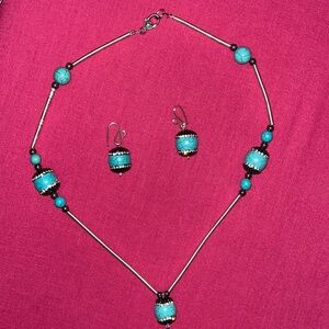 Handmade jeweled necklace with turquoise colored accents. Matching earrings.